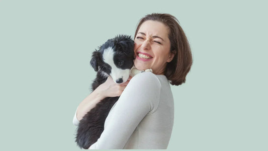 Pet owner hugging dog.